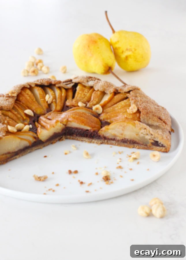 Rustic Pear & Chocolate Almond Galette 8 A slice of Pear and Chocolate Frangipane Galette on a plate, ready to be served. // FoodNouveau.com