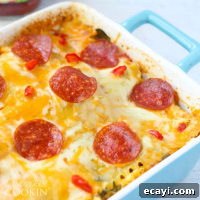 Pizzagna 16 A close up photo of the finished, baked pizza lasagna in a blue casserole dish, golden and bubbly.