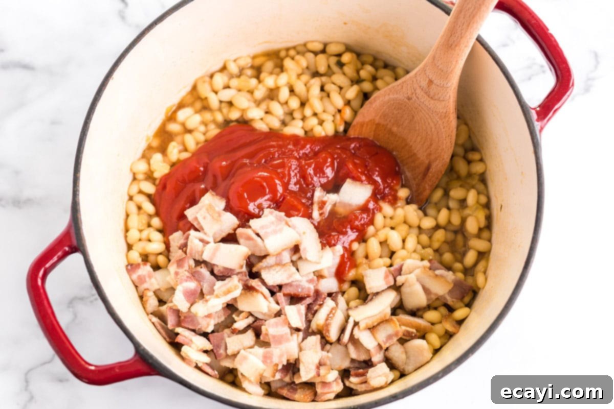 Grandma's Classic Baked Beans 9 ketchup, bacon, and bean mixture in a pan