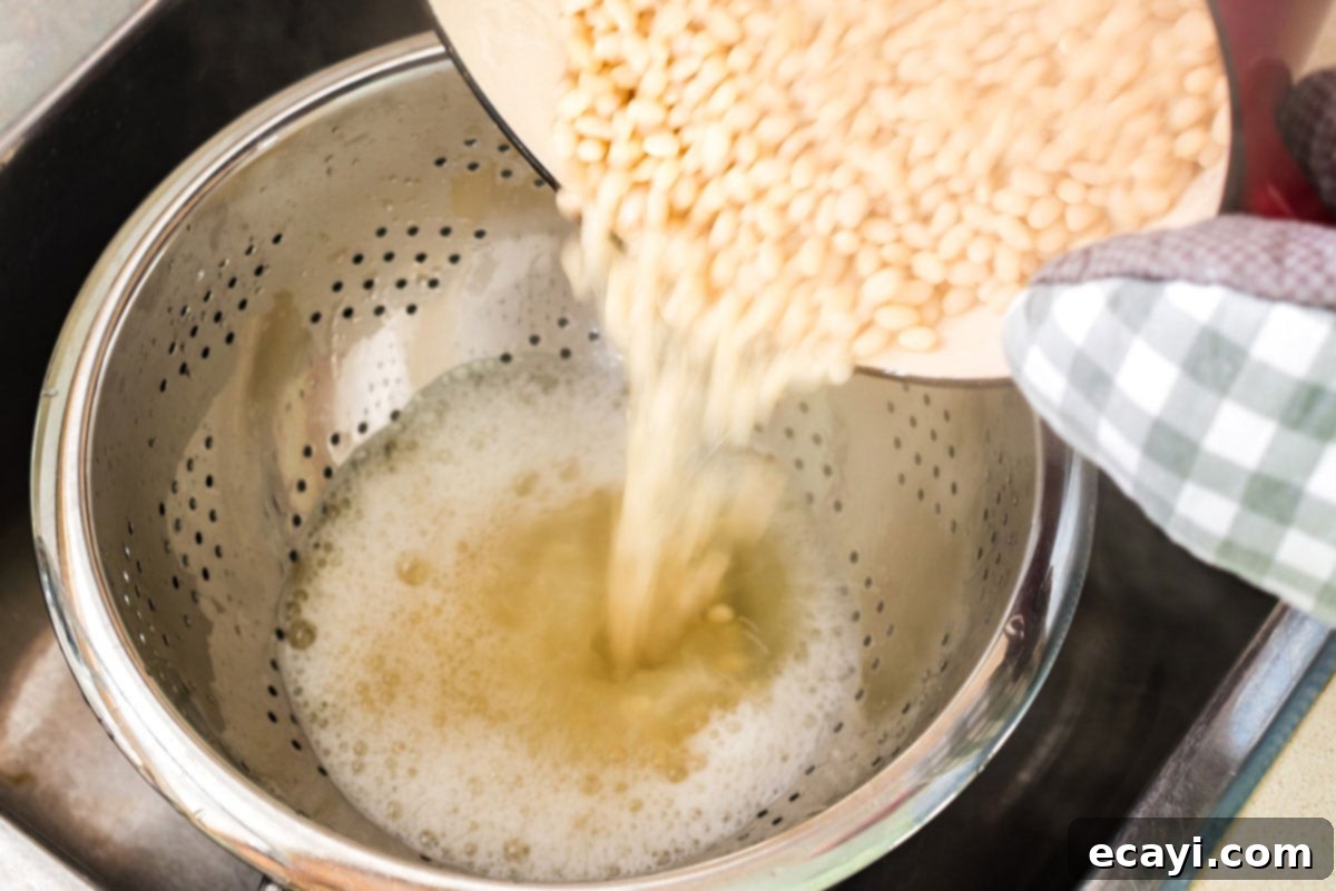 Grandma's Classic Baked Beans 6 draining beans into a collander