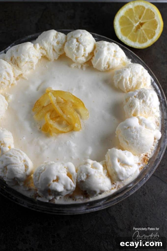 Lemon Icebox Dream Pie 3 A vibrant frozen lemonade pie, glistening under soft light, ready to be served on a summer day.