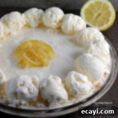Lemon Icebox Dream Pie 6 A plate of frozen lemonade pie with a banana on a table, ready to be enjoyed.