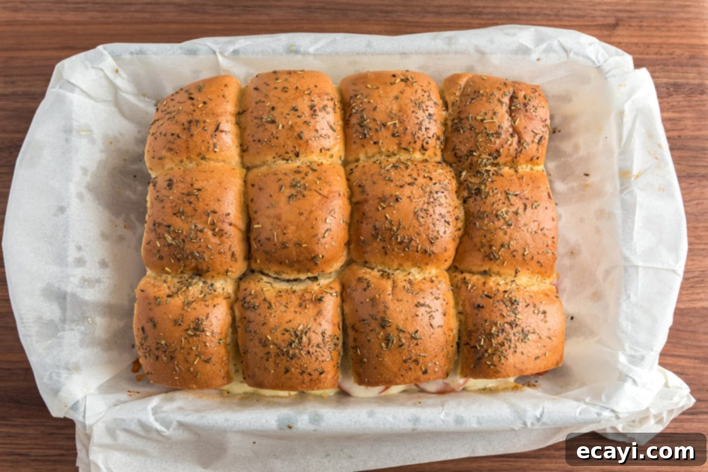 Cheesy Pizza Bites 12 A baking dish filled with freshly baked pizza sliders, golden brown and cheesy