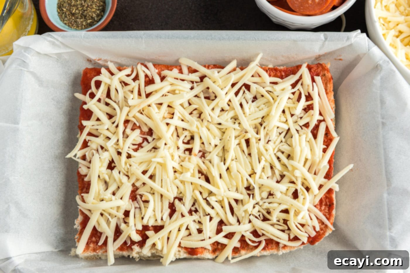 Cheesy Pizza Bites 7 Shredded mozzarella cheese generously spread over pizza sauce on slider buns