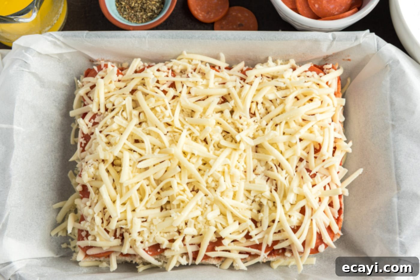 Cheesy Pizza Bites 9 A second layer of shredded mozzarella cheese sprinkled over pepperoni and the first cheese layer on the pizza sliders