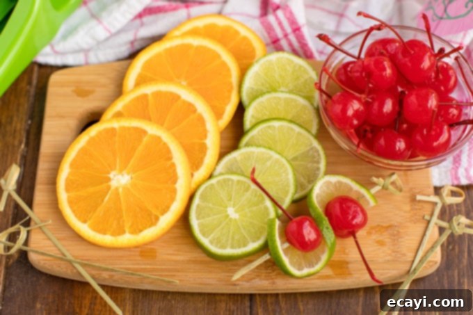 Punch of Paradise 5 Sliced oranges and limes with maraschino cherries on a cutting board, ready for garnishing