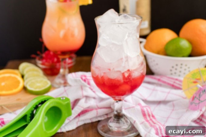 Punch of Paradise 8 A glass filled with ice, showing the layer of grenadine settled at the bottom