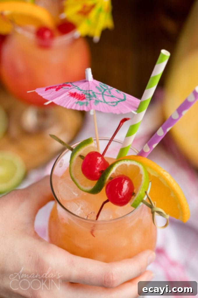 Punch of Paradise 10 A hand holding a garnished glass of rum punch, ready to be enjoyed