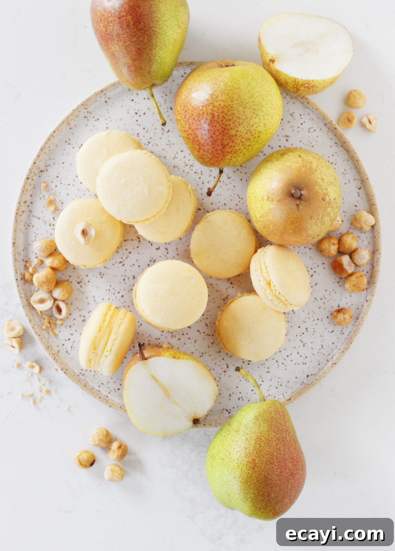 Artisan Hazelnut Pear Macarons 2 Irresistible Hazelnut Pear French Macarons with Frangelico-infused pear cream // FoodNouveau.com