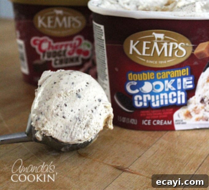 Freakshakes Wildly Indulgent Shakes 3 A close-up photo of a scoop of creamy ice cream, with distinct Kemp's ice cream containers visible and slightly out of focus in the background, hinting at quality ingredients.