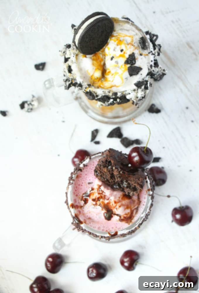 Freakshakes Wildly Indulgent Shakes 4 An overhead shot showcasing two extravagant freakshakes side-by-side: a rich cherry fudge chunk on the left and a decadent double caramel cookie crunch on the right, both expertly garnished.