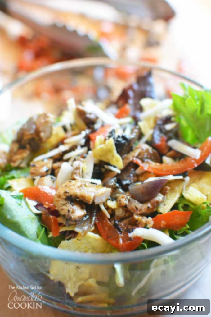 Delicious and healthy Chicken Fajita Salad ready to be served Close-up of Chicken Fajita Salad in a bowl, showing chicken strips, peppers, onions, and lettuce