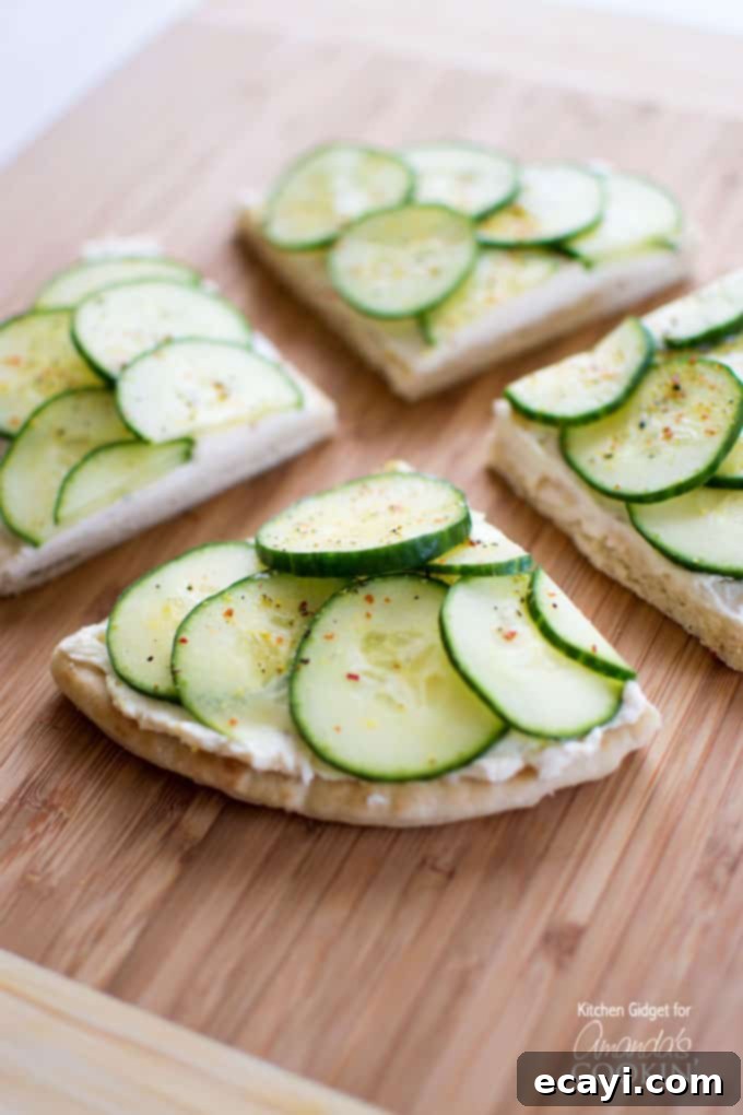 What do you get when you combine crisp cucumbers, zesty cream cheese, and soft pita bread? These mouthwatering cucumber sandwiches! Cucumber Sandwiches with cream cheese on pita bread.