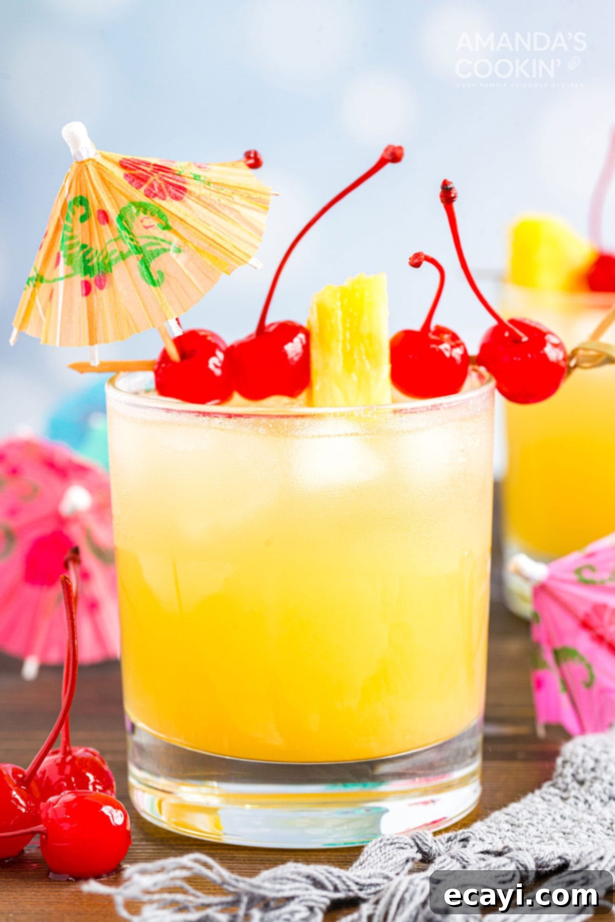 A basic Mai Tai is easy to make. This rum cocktail has combines almond, lime, and tropical fruit flavors. Great for summer and reminds you of the beach! A vibrant Mai Tai cocktail in a rocks glass, garnished with a classic cocktail umbrella and a lime wedge, evoking tropical beach vibes.