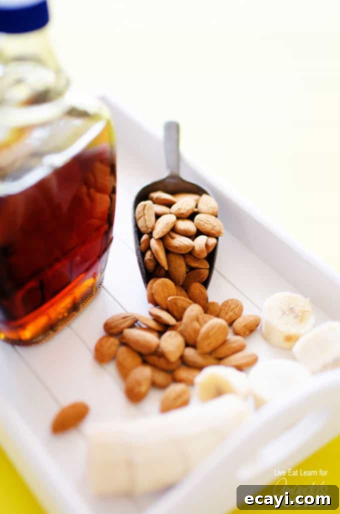 Velvety Almond Maple Delight 3 A close up photo of a jar of maple syrup and a scoop of almonds.