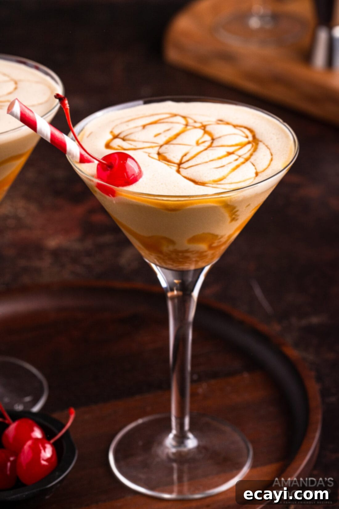 Butterscotch Velvet Sip 2 butterscotch milkshake cocktail in a martini glass with a cherry garnish