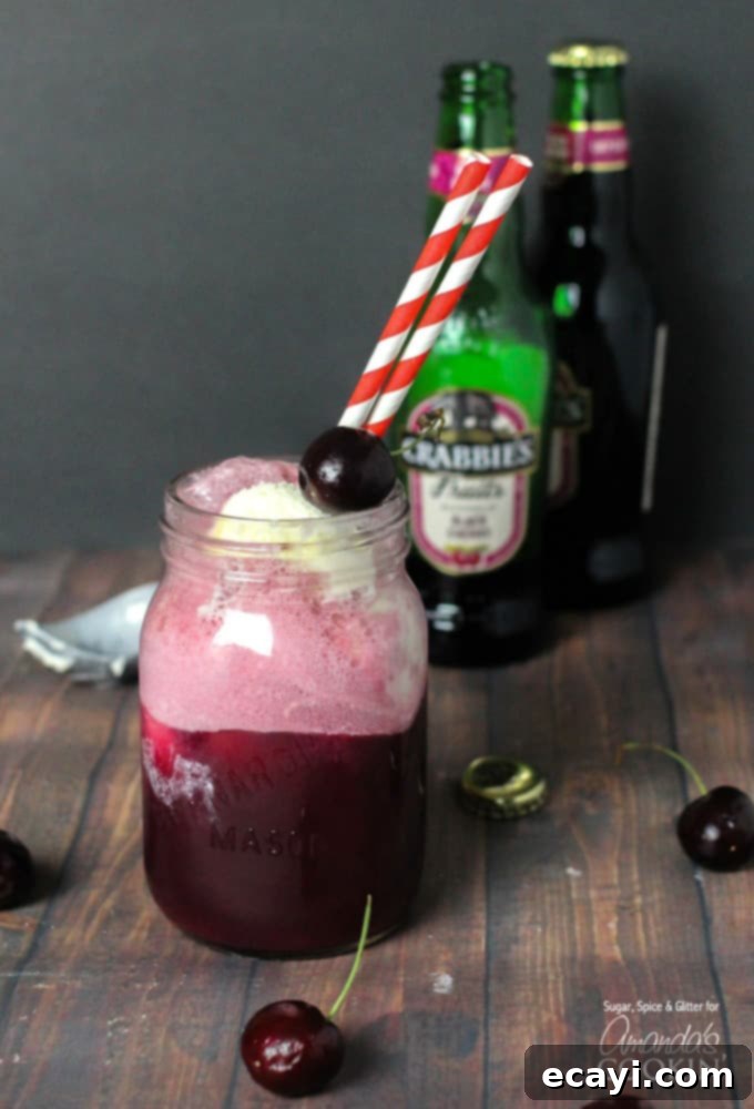 Velvet Cherry Dream 2 A charming mason jar brimming with a frothy black cherry float cocktail, garnished with fresh cherries and colorful red and white striped straws.