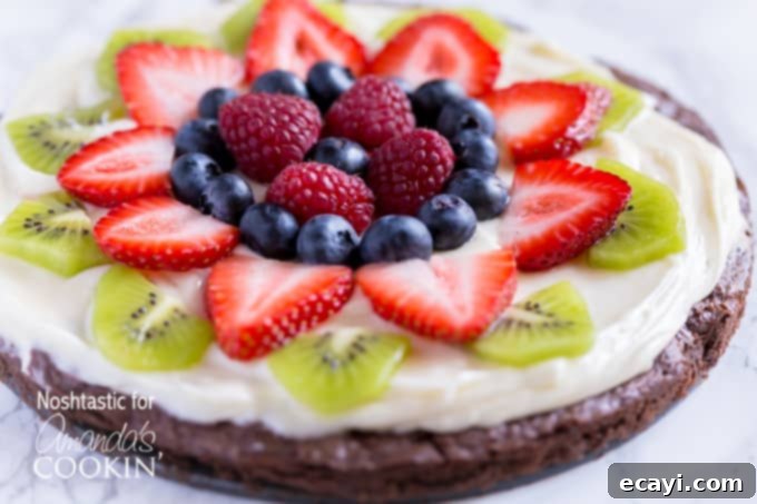 Effortless Fruit Tart 4 A close up of cut up fruit on top of a brownie pizza.