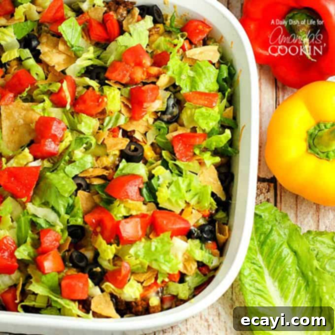 This delicious and hearty taco casserole will quickly become a family favorite. Seasoned beef, tasty beans, melty cheese and salsa with just enough chips! Taco casserole in dish