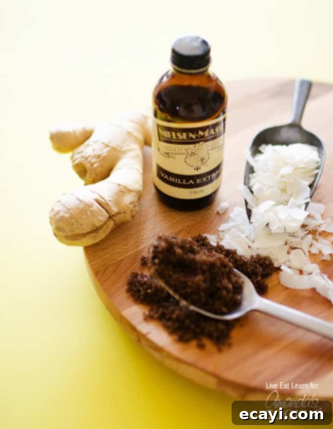 Creamy Coconut Bliss 4 A photo of some of the needed ingredients to make a cozy coconut smoothie: shaved coconut, packed brown sugar, ginger and vanilla extract.