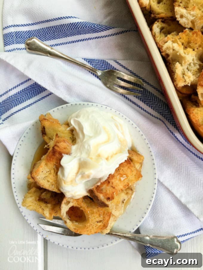 Overnight French Toast Bake 2 An overhead of french toast casserole on a white plate topped with vanilla whipped cream.