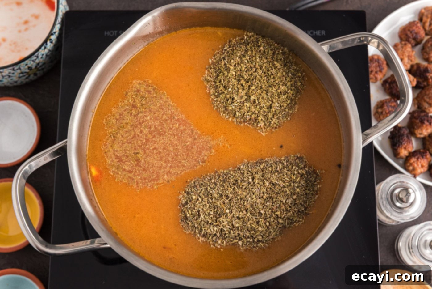 Hearty Sausage Orzo Soup 9 seasonings added to soup in pot