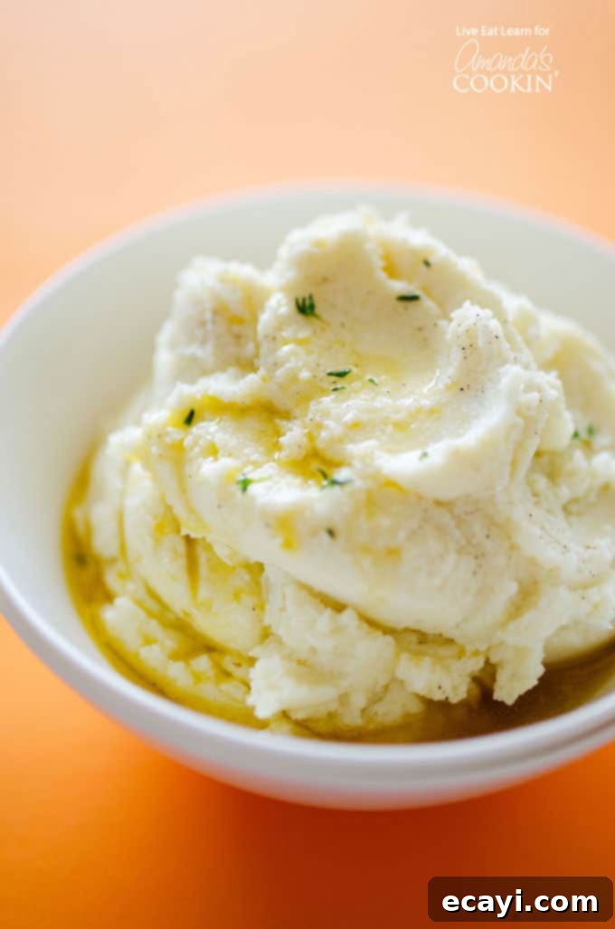 Velvet Cauliflower 3 A close up of mashed cauliflower with melted butter on top.