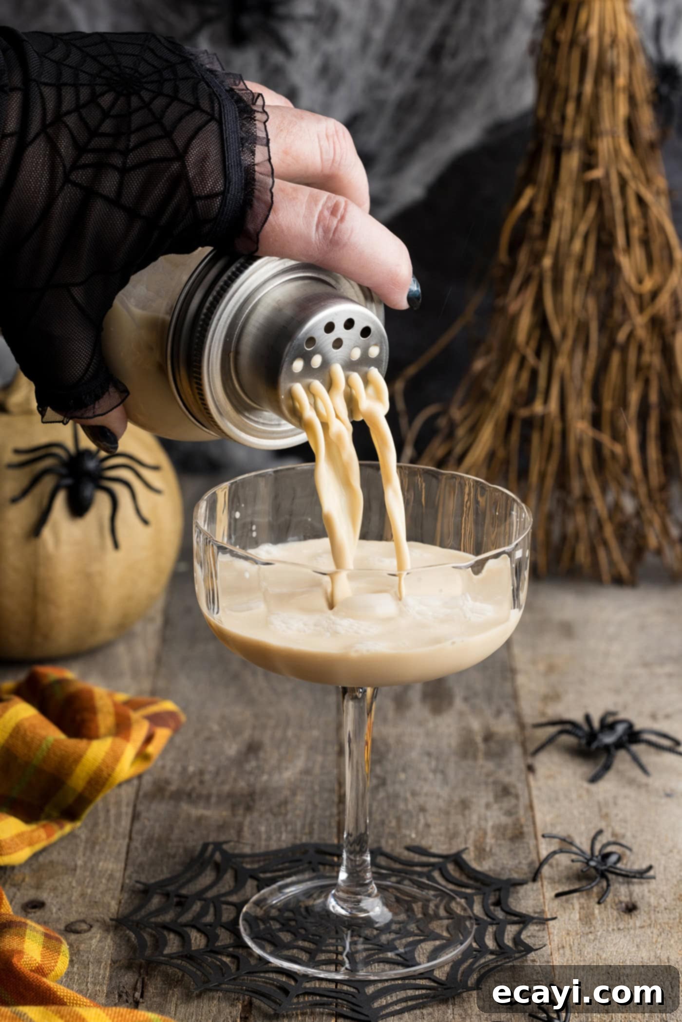 Cobweb Elixir 7 straining a White Russian cocktail into a coupe glass