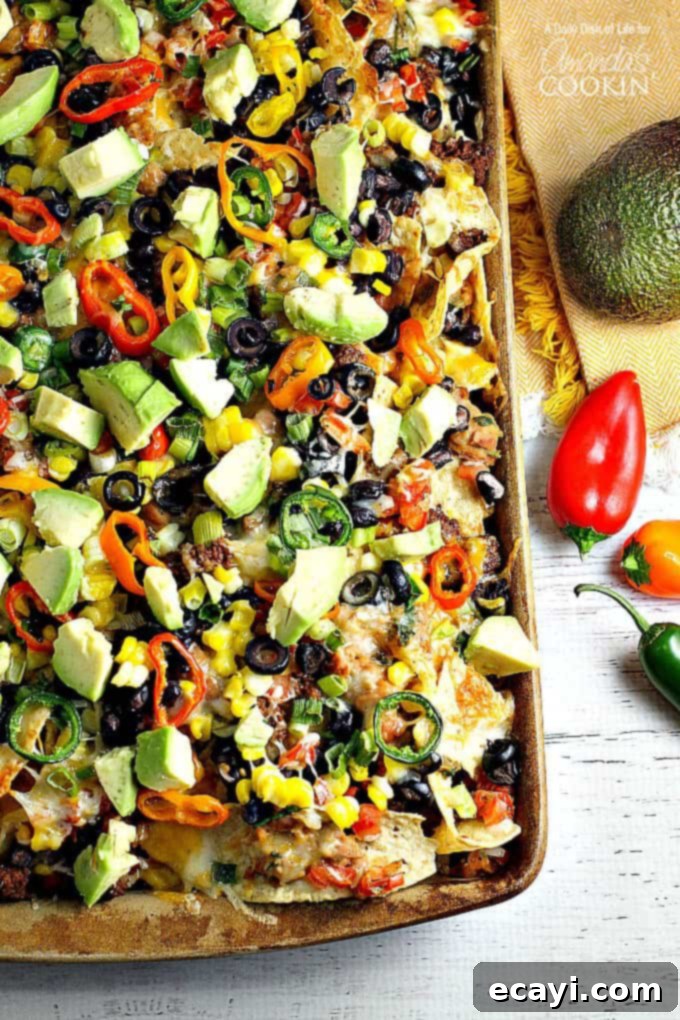Ultimate Nacho Feast 2 An overhead of loaded nachos on a sheet pan.
