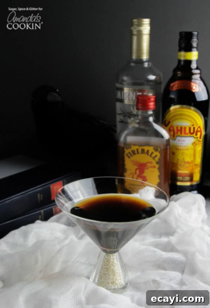 Nevermore Coffee Cocktail 2 A photo of a raven coffee cocktail in a martini glass, garnished with a feather.