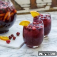Ruby Red Sangria 2 Two glasses of festive cranberry sangria, beautifully garnished and ready for a celebration.