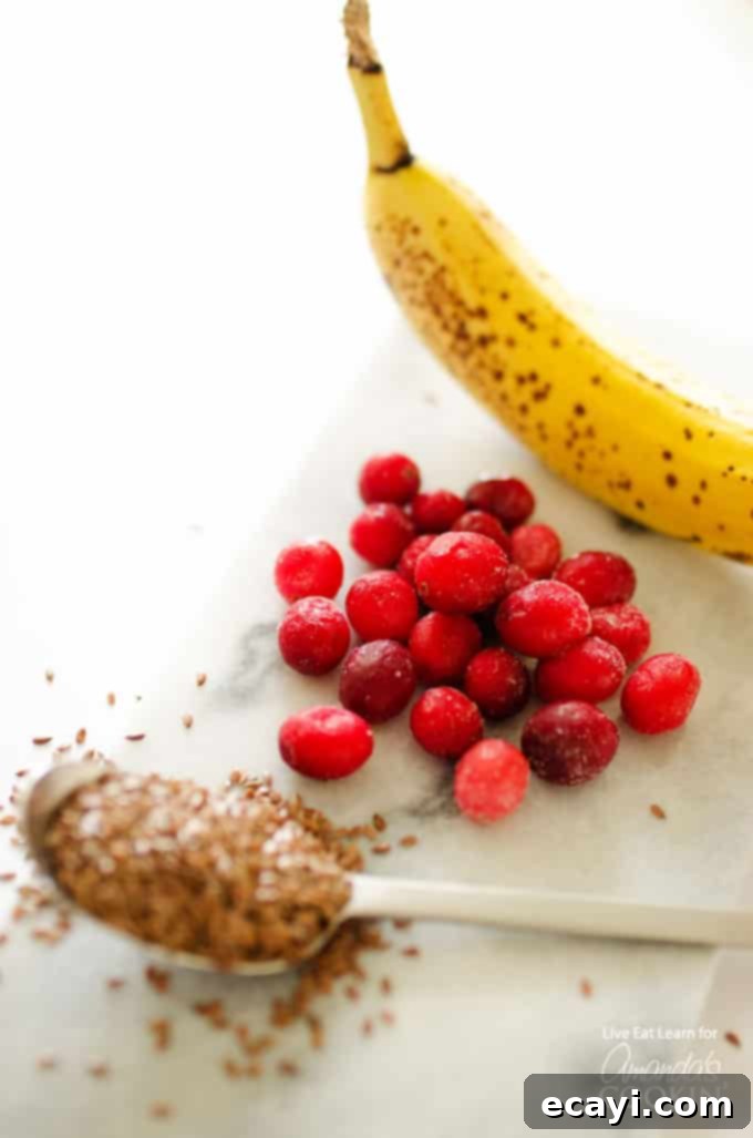 Holiday Reset: Cranberry Cleanse Smoothie 3 A photo of a banana, cranberries and spoonful of flax seeds.