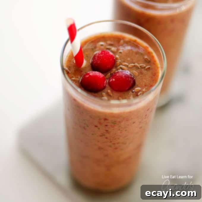 Holiday Reset: Cranberry Cleanse Smoothie 5 Cranberry Smoothie in s glass with straw