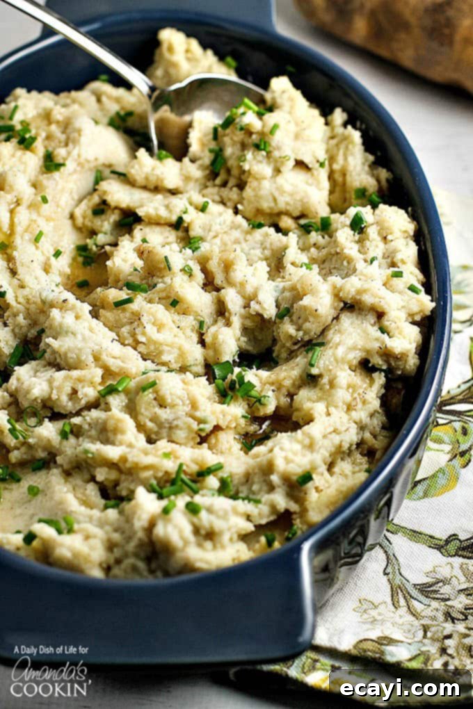 Golden Brown Butter Mash 2 A close up overhead picture of brown butter mashed potatoes, garnished with fresh herbs, showcasing their creamy texture and golden hue.