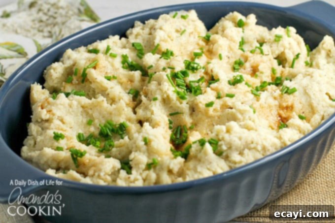 Golden Brown Butter Mash 3 A beautifully presented bowl of creamy brown butter mashed potatoes, topped with fresh green chives for a pop of color and freshness.