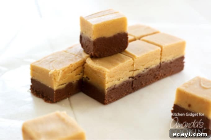 Chocolate chips, peanut butter, marshmallow fluff, and evaporated milk and a few more ingredients make delicious two layered chocolate peanut butter fudge. A beautiful stack of creamy, homemade chocolate peanut butter fudge squares, perfectly layered and ready to enjoy.