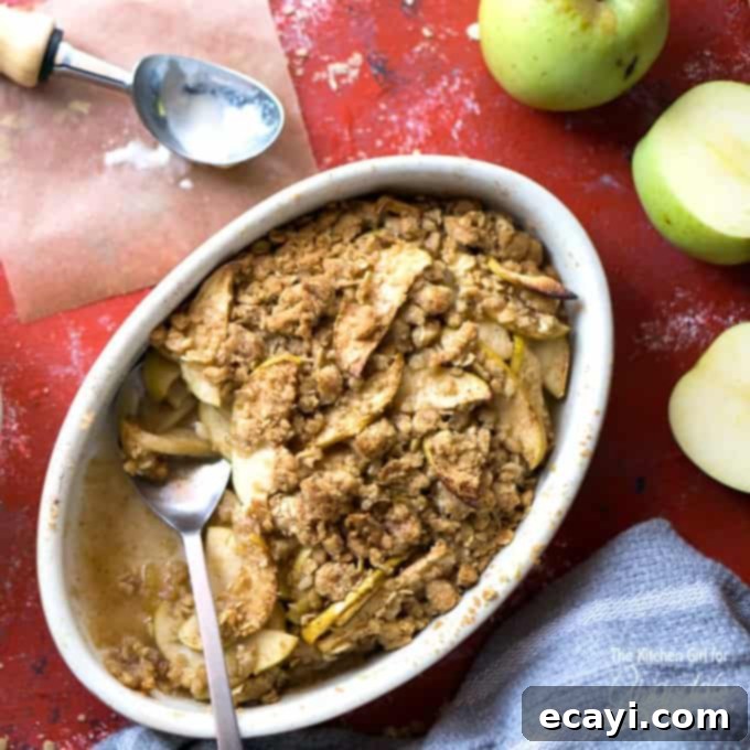 Rustic Apple Pie Perfection 8 A bowl of apple crisp topped with whipped cream and a spoon, suggesting a delightful alternative dessert.