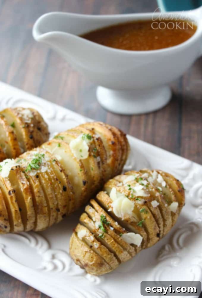 Golden Fan-Cut Potatoes 15 A plate featuring perfectly cooked Hasselback potatoes, fanned out and golden, showcasing the crispy texture and delicious garnish.