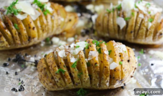 Golden Fan-Cut Potatoes 9 Hasselback potatoes step 3: The partially baked potatoes on a baking sheet, brushed with butter and herbs, showing the fanned-out texture developing.