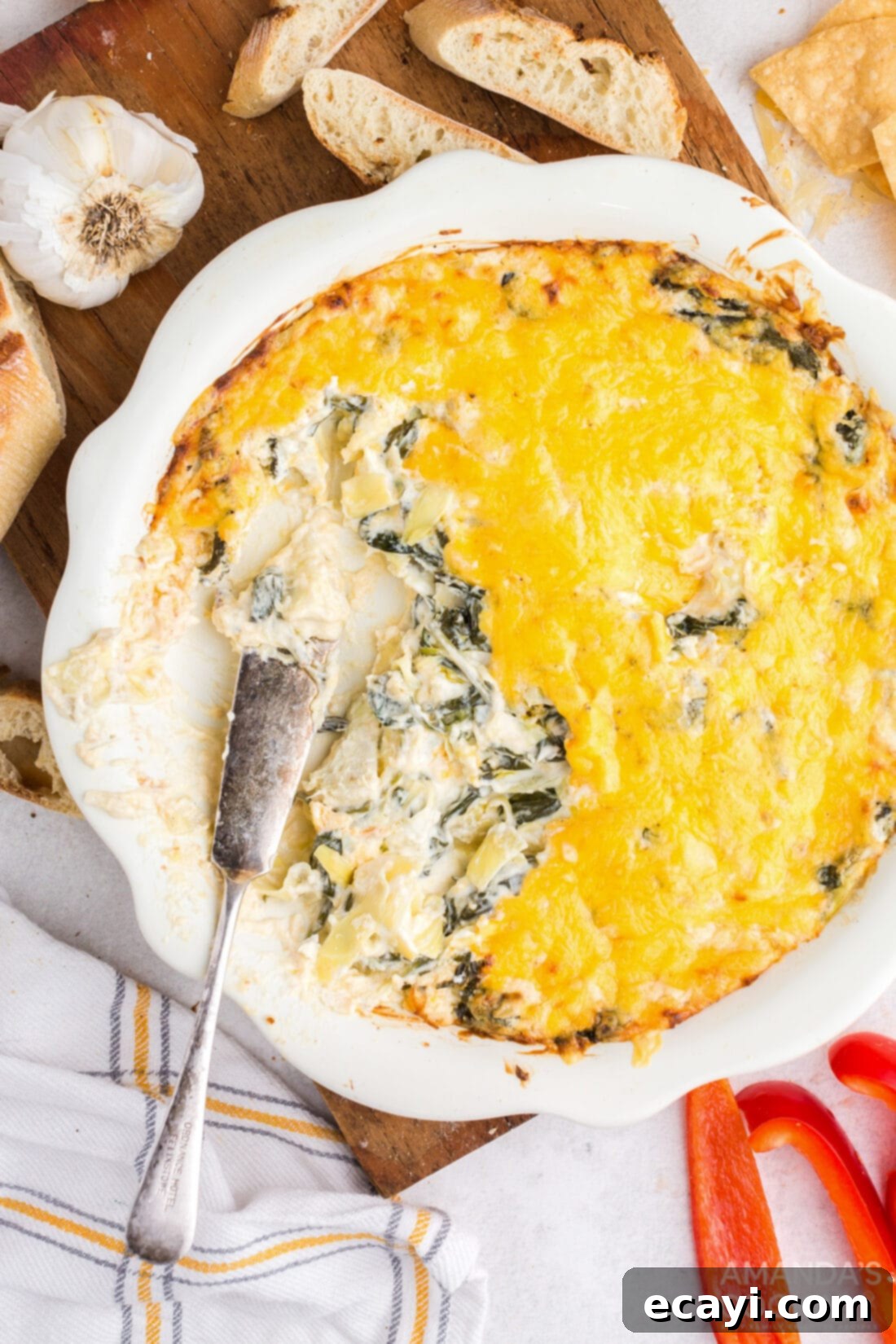 Piping Hot Cheesy Spinach Delight 2 dish of hot spinach dip with some taken out