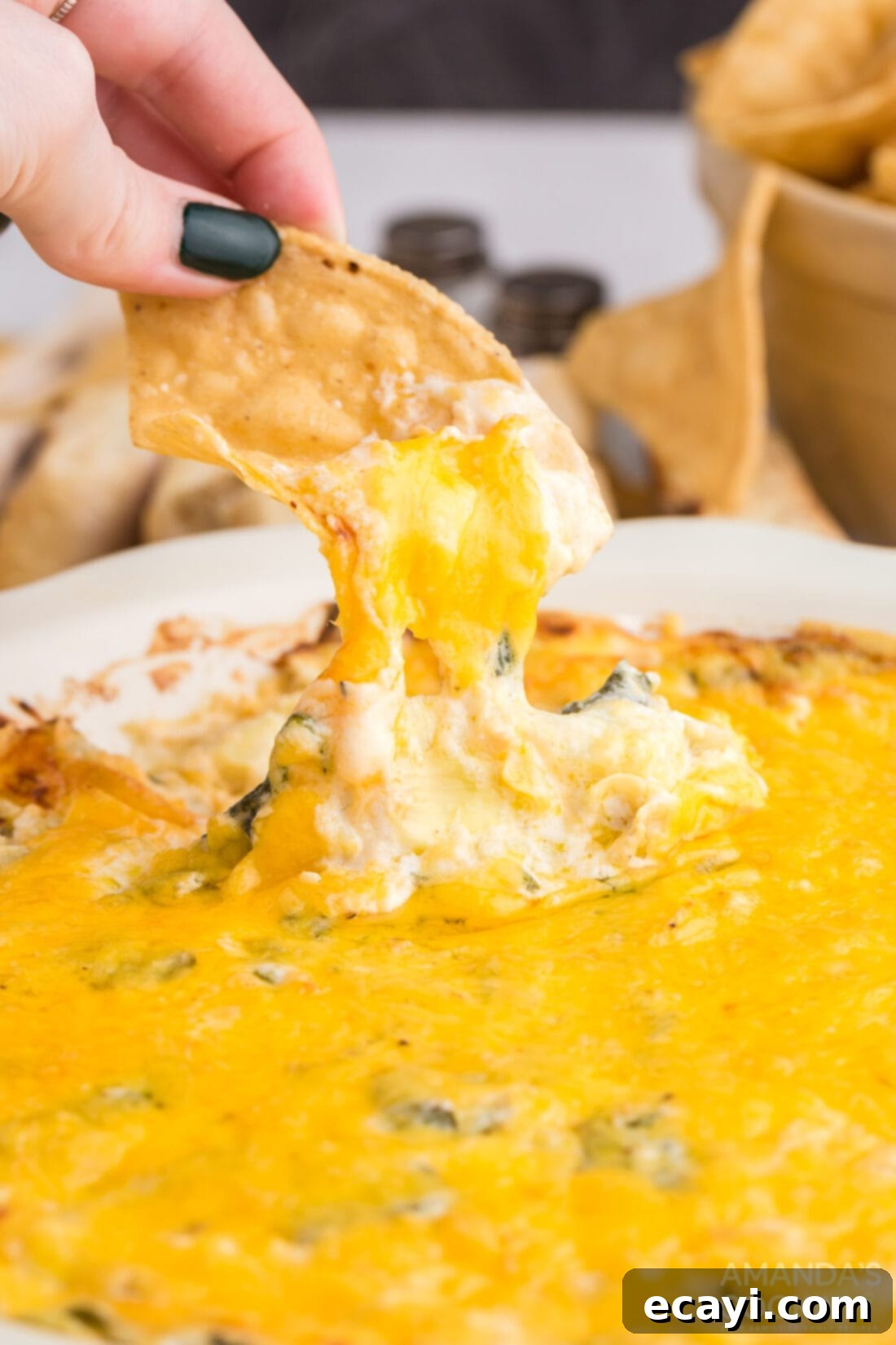Piping Hot Cheesy Spinach Delight 3 dipping chip in spinach dip