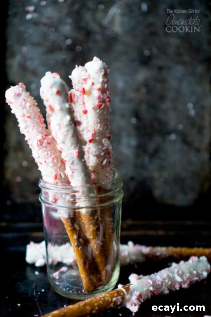 Holiday Minty Pretzel Crunch 2 A photo of white chocolate candy cane pretzel sticks in a clear jar.
