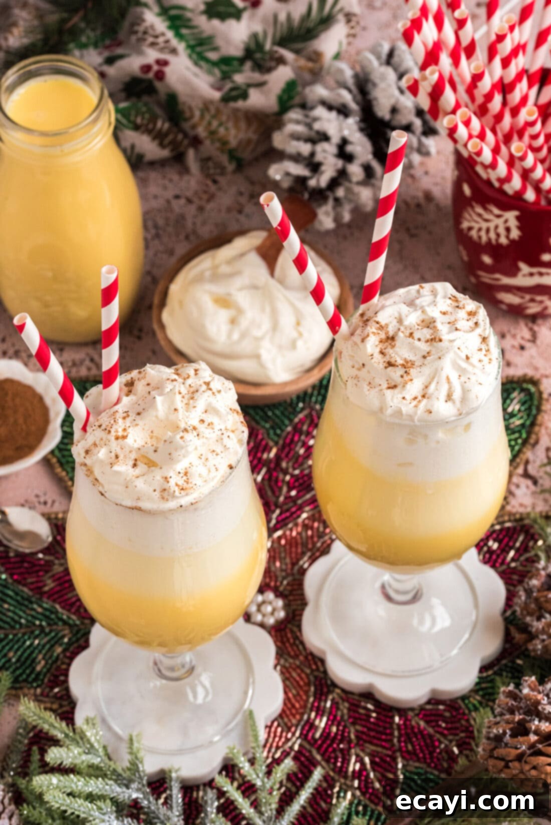Creamy Eggnog Delight 3 Two festive Eggnog Floats generously topped with whipped cream, ready to be served