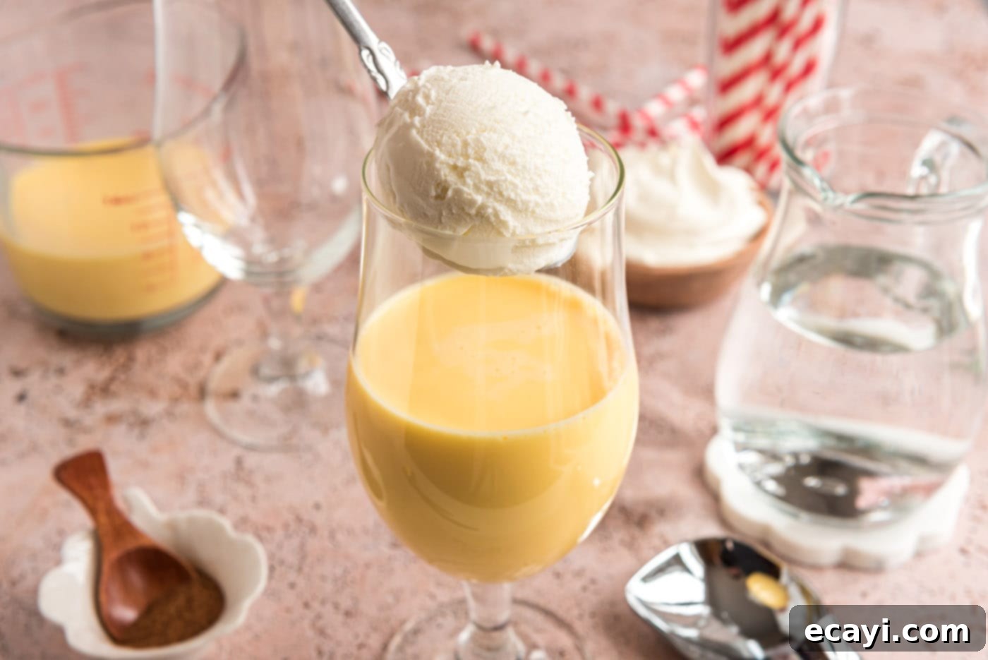 Creamy Eggnog Delight 6 Adding a scoop of creamy vanilla ice cream to a glass filled with eggnog