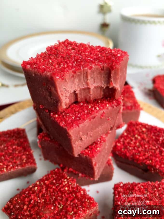 Decadent Red Velvet Fudge 7 A close-up macro photograph of a single piece of red velvet fudge, showing its inviting texture and sprinkles, ready for a taste.