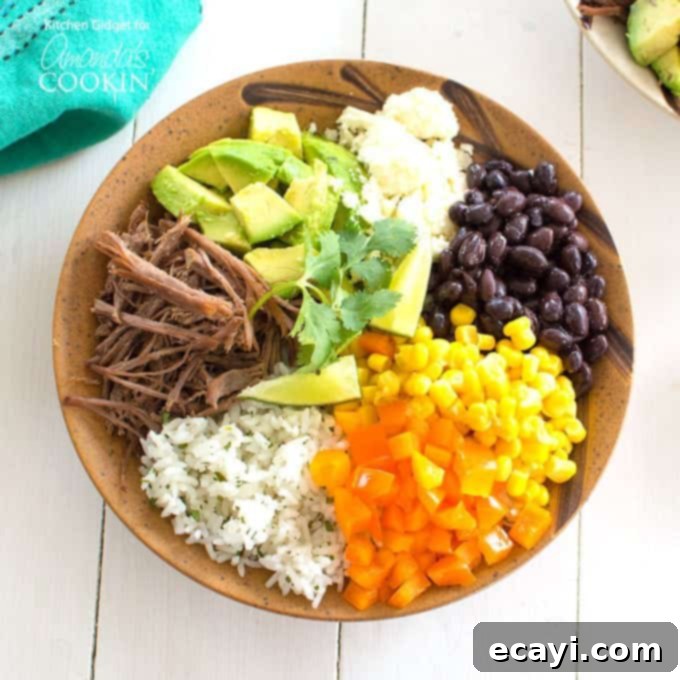 Naked Burrito 3 An overhead of a brown bowl filled with white rice, bell pepper, corn, black beans, crumbled queso fresco, avocado, lime and cooked beef.