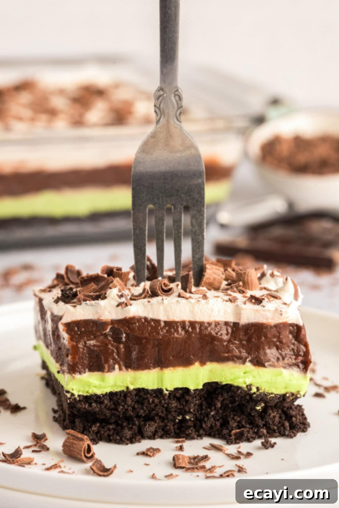 No-Bake Mint Chocolate Lasagna 2 Fork stuck in a slice of Mint Chocolate Lasagna