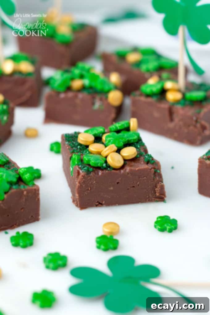 This Baileys Irish Cream Chocolate Fudge is a decadent, flavorful, and rich chocolate fudge recipe infused with Baileys Irish Cream. You'll love this one! #fudge #stpatricksday #chocolate #chocolatefudge #baileys #irish #stpattysday #dessertrecipes #candy Baileys Irish Cream Chocolate Fudge with sprinkles