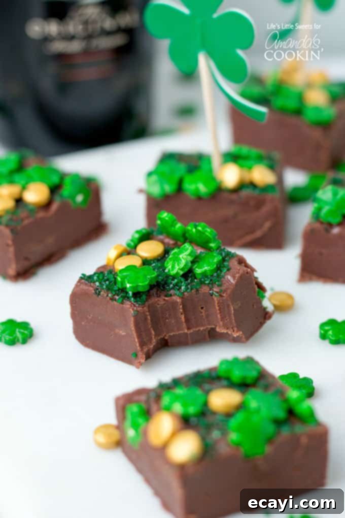 This Baileys Irish Cream Chocolate Fudge is a decadent, flavorful, and rich chocolate fudge recipe infused with Baileys Irish Cream. You'll love this one! #fudge #stpatricksday #chocolate #chocolatefudge #baileys #irish #stpattysday #dessertrecipes #candy Bailey's Irish Cream Chocolate Fudge with bite taken out