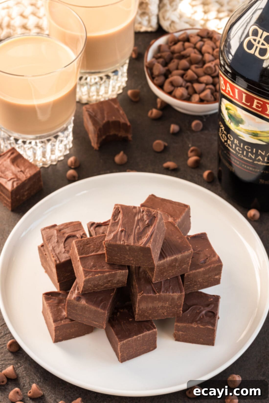 Effortless 4 Ingredient Baileys Fudge 2 Close-up of perfectly cut squares of rich Bailey's fudge on a white plate